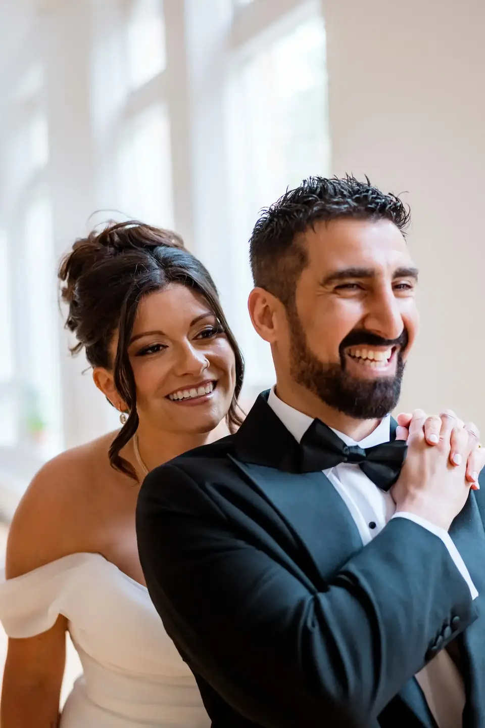 Bride and groom laughing together inside The Harlow Exchange
