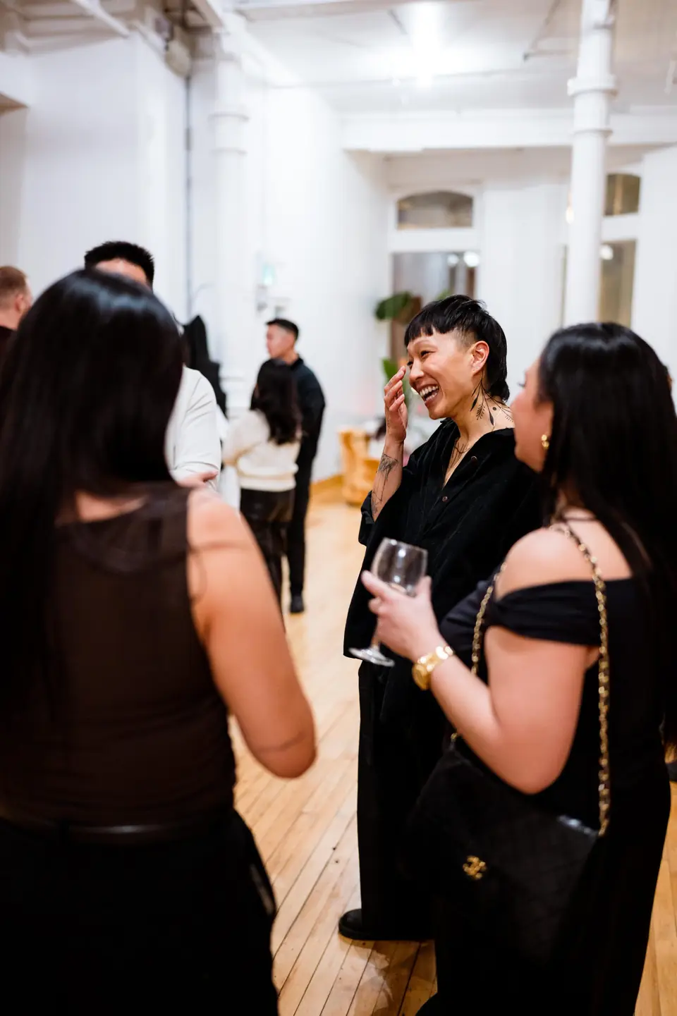 Guests mingling with drinks at an evening reception