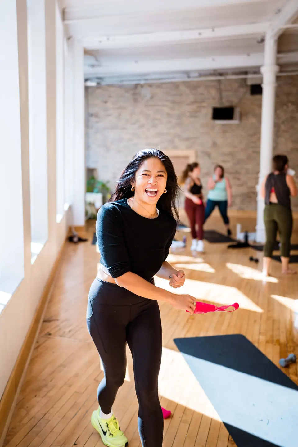 Fitness instructor smiling while leading a class
