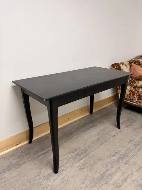 Black wooden table at The Harlow Exchange