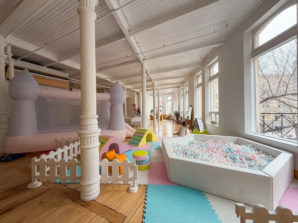 Ball pit, soft play and bounce castle for a kids party under the white columns