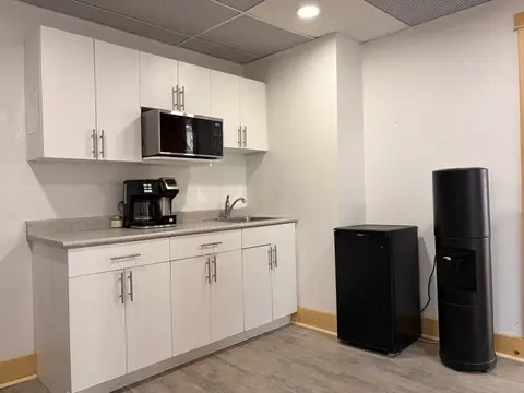 Kitchenette with sink, microwave, coffee machines and fridge in the prep room