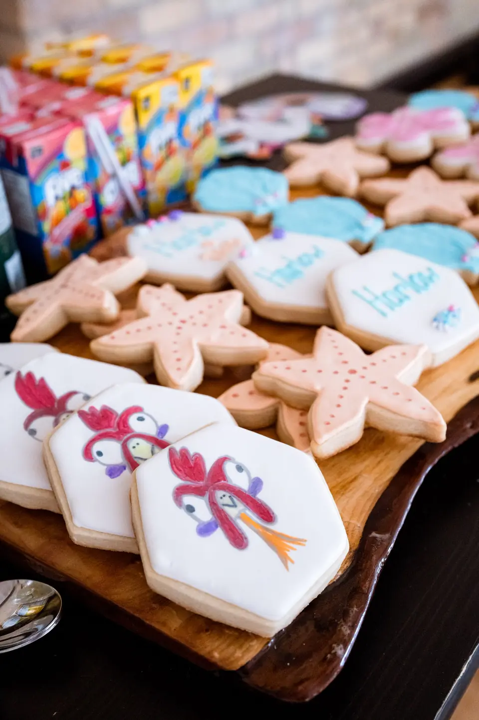 Hand-decorated cookies on a wooden serving board