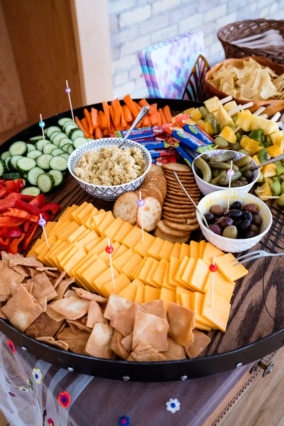 Colourful grazing board with cheese, crackers and vegetables