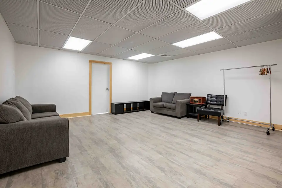 Private prep room with sofas, cubbies and a coat rack