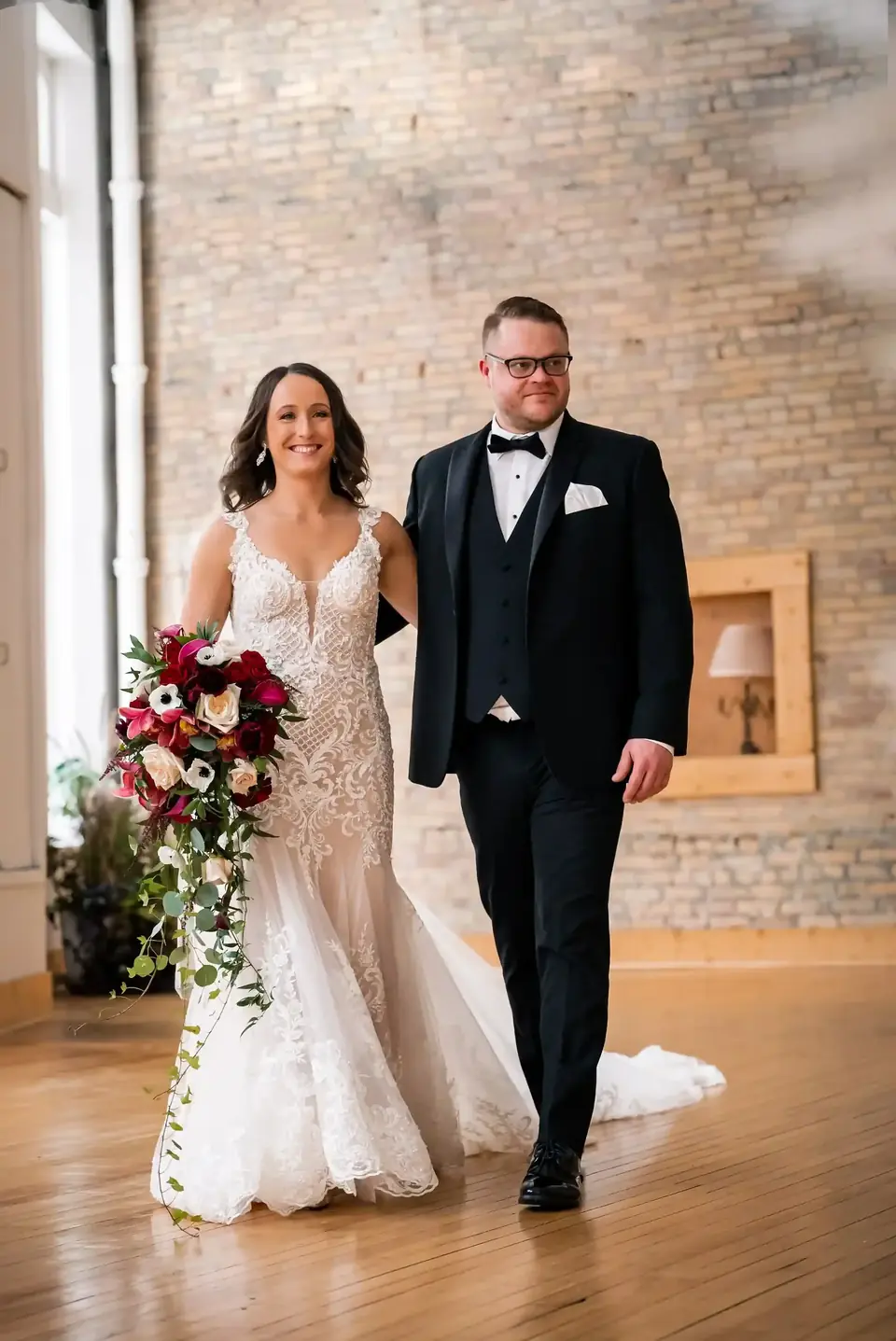 Bride and groom walking hand in hand through the main hall