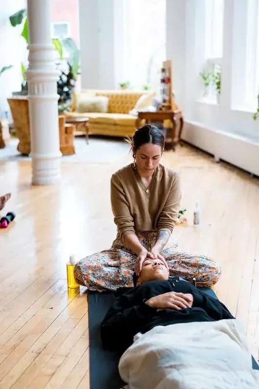 Practitioner leading a one-on-one wellness session in the main hall